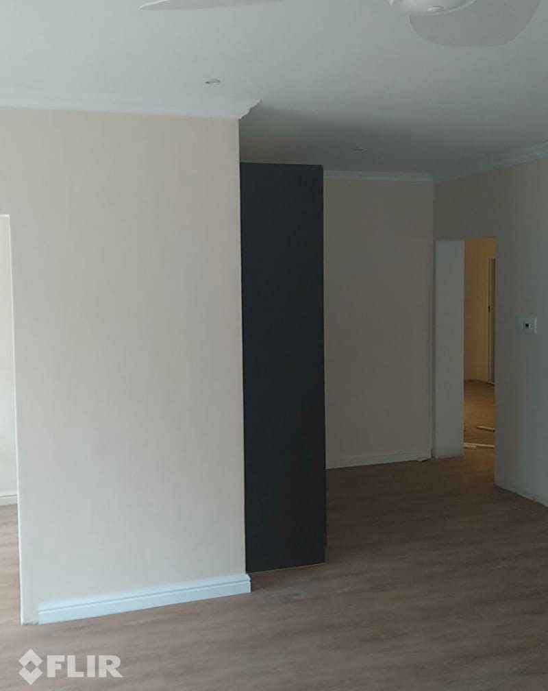 Finished living room with a plastered and painted wall that has carbon fibre heating film behind it, nothing visible on the surface