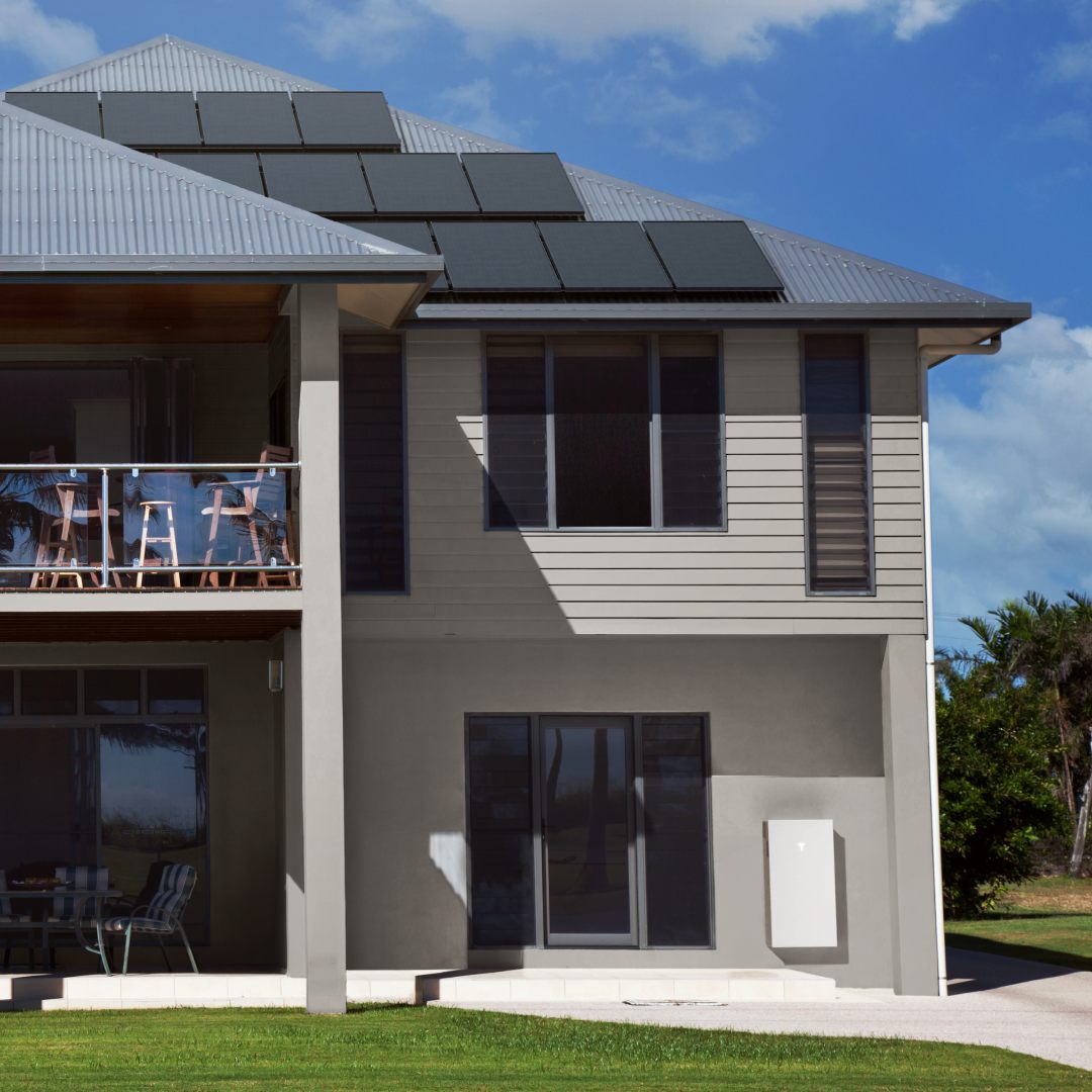 Tesla Powerwall 3 mounted on a modern South African home with rooftop solar panels, designed for whole-home backup during load shedding
